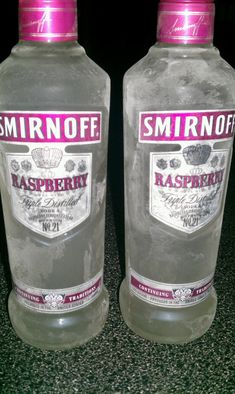 two bottles of vodka sitting next to each other