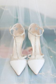 the bride's shoes are all white and have beading on them