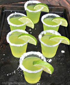 several glasses filled with limeade and topped with sugar