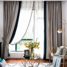 a living room filled with furniture and curtains