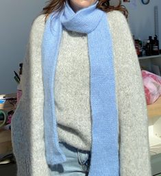 a woman wearing a blue scarf and hat