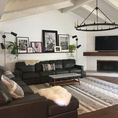 a living room filled with furniture and a flat screen tv mounted on the wall above a fireplace