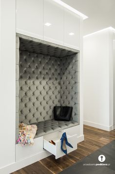 a white closet with some shoes in it