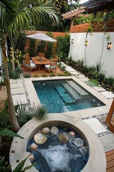 A cozy backyard featuring a small pool and hot tub surrounded by lush greenery, with a wooden dining set and umbrella under a pergola. Small Garden With Small Pool, Micro Pool Backyard, Small House Pool, Small Pool Design For Small Yards, Small Backyard Ideas With Pool, Pool Porch Ideas, Small Backyard Pool Landscaping, Beach Backyard Ideas, Small Backyard With Pool