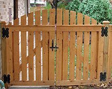 a wooden gate with an iron handle on it