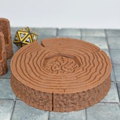 a chocolate cake sitting on top of a tile floor next to two small wooden blocks