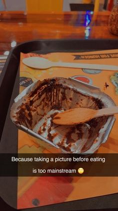 a wooden spoon sitting in a pan on top of a table