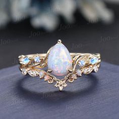 Nature Inspired  Jewelry, Twig Opal Ring Set , 10K Gold, Teardrop Ring, Branch Engagement Ring, Moonstone Wedding Ring , October Birthstone, Birthday Gifts Main Ring : 6*8mm Pear cut Lab white opal. Side stone : Moonstone Matching Band: Moissanite and opal. Material Metal: 925 sterling silver, Solid 14k/18k gold, platinum PLEASE choose silver or platinum if you are allergic to nickel. This jewelry is made to order, it can be made with any gemstone/metals. 2-3 weeks to finish. Default Shipping me Fire Opal Wedding Rings, Sun Ring Engagement, Real Opal Engagement Ring, Simple Engagement Ring Sets, Topaz And Opal Ring, Opalite Wedding Ring, Opal Ring Set, Pearl And Opal Engagement Ring, Whimsical Wedding Ring Set