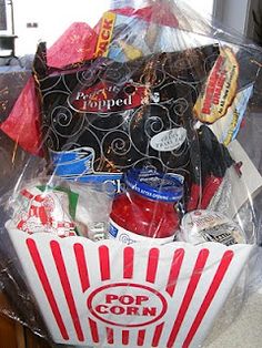 a popcorn bucket filled with snacks and condiments