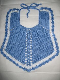 a blue crocheted bib with white trim