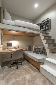 a loft bed with a desk underneath it and stairs leading up to the upper level