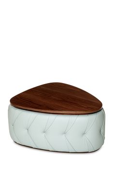 a white ottoman with a wooden top