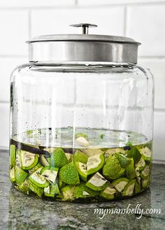 a glass jar filled with pickles on top of a counter