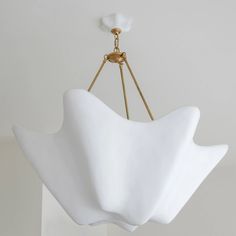 a white light fixture hanging from the ceiling