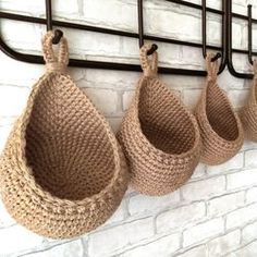 several baskets hanging on a brick wall