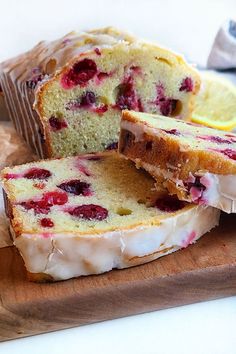 a loaf of lemon raspberry bread on a cutting board with slices cut out