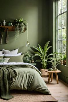 a bedroom with green walls and plants in the corner