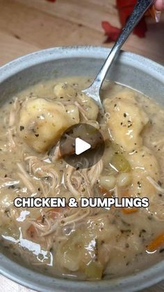 a bowl of chicken and dumplings soup with a spoon