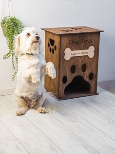 a dog standing on its hind legs in front of a wooden box