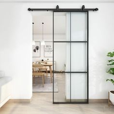 an open glass door leading to a dining room