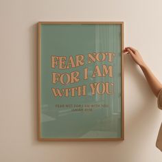 a woman holding up a poster with the words fear not for i am with you