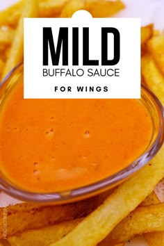 mild buffalo sauce for wings in a glass bowl on top of french fries with the words mild buffalo sauce above it