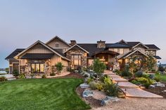 a large house with lots of windows and landscaping