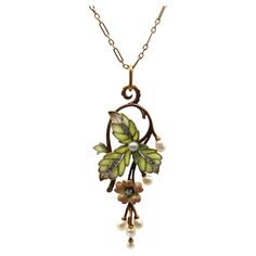 A classic Art Nouveau design, this 15k rose gold necklace features stunning plique-à-jour, Rose Cut diamonds, and beautiful pearls. The centerpiece of the necklace is articulated, hinged in two places so that the flower and pearl drops dangle freely. Three plique-à-jour leaves are translucent—the loveliest matte soft green that fades into subtle purple highlights, clearly done by a master. Each cell of the leaf is filled with plique, with a white metal (platinum or white gold) creating contrast Designer Pendant Sets, Subtle Purple Highlights, Diamond And Pearl Necklace, Design Art Nouveau, Art Nouveau Necklaces, Bijoux Art Nouveau, Art Nouveau Pendant, Purple Highlights, Art Nouveau Design