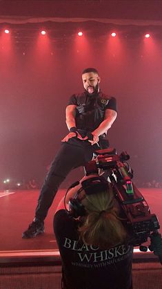 a man is sitting on the back of a woman's head at a concert