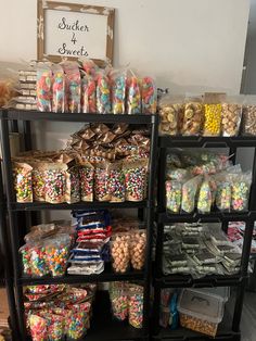 a shelf filled with lots of different types of candy and candies on it's sides