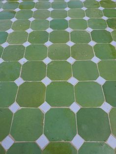 an image of a green tile floor that looks like hexagonal tiles