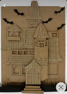 a paper cut out of a house with bats on it