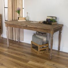 a wooden table sitting on top of a hard wood floor