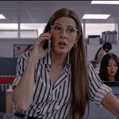 a woman talking on a cell phone in an office