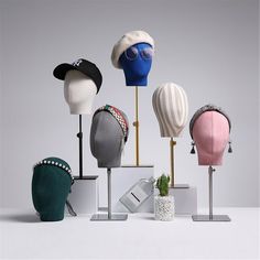 several hats are on display in front of a white background