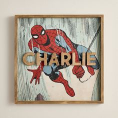 a wooden sign with the word charlie spelled in wood and spider - man on it