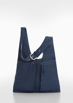 a blue striped bag on a white surface with the strap down to it's shoulder