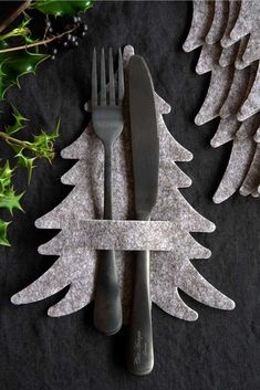 a fork and knife sitting next to each other on top of a black table cloth