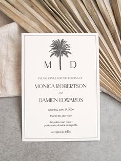 an elegant palm tree is the centerpiece of this monogrammed wedding card design