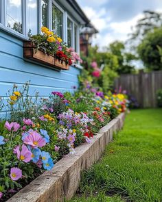 colorful flowers line the side of a blue house