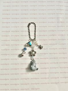 a keychain with charms attached to it on top of a sheet of paper