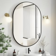 a bathroom sink with a round mirror above it next to a white counter top and green plants