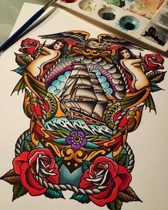 a drawing of a ship surrounded by roses and other things on the table with paintbrushes