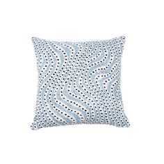 a blue and white pillow with black dots on it