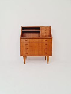 an old wooden dresser with drawers on the top and bottom, against a white background