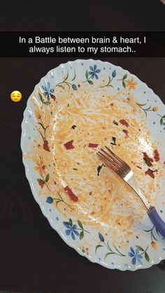 a white plate topped with spaghetti and a fork