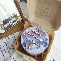 a birthday cake in a box on a table