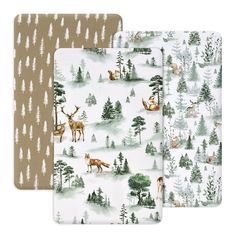 three placemats with deer and trees on them, one in white and the other in brown