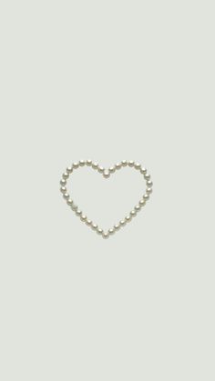 a heart made out of pearls on a white background