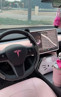 the interior of a car with pink leather seats and steering wheel controls, including a hello kitty dashboard